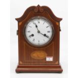 An early 20th century mahogany and box wood strung mantel clock, the enamel dial showing Roman