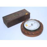 An early 20th century carved oak wall aneroid barometer, dia,. 23cm, together with a carved box