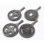 A set of four cast iron trivets