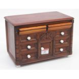 A 20th century hardwood table top chest, containing an arrangement of eight short drawers, width