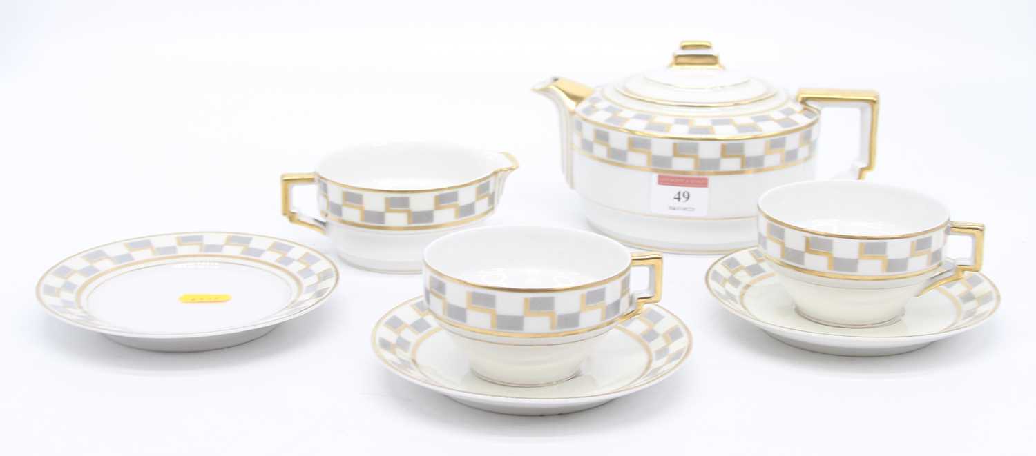 A Limoges Art Deco style part teaset with geometric decoration, comprising teapot, milk jug, side