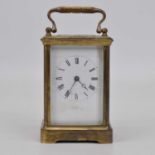 An early 20th century brass cased carriage clock, the enamel dial showing Roman numerals, and signed