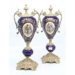 A pair of reproduction gilt metal mounted urns, each decorated with flowers, height 46cm