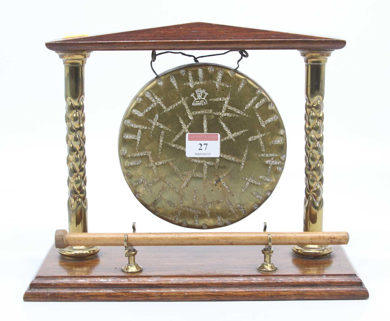 A Burmese oak and brass table gong, height 24cm