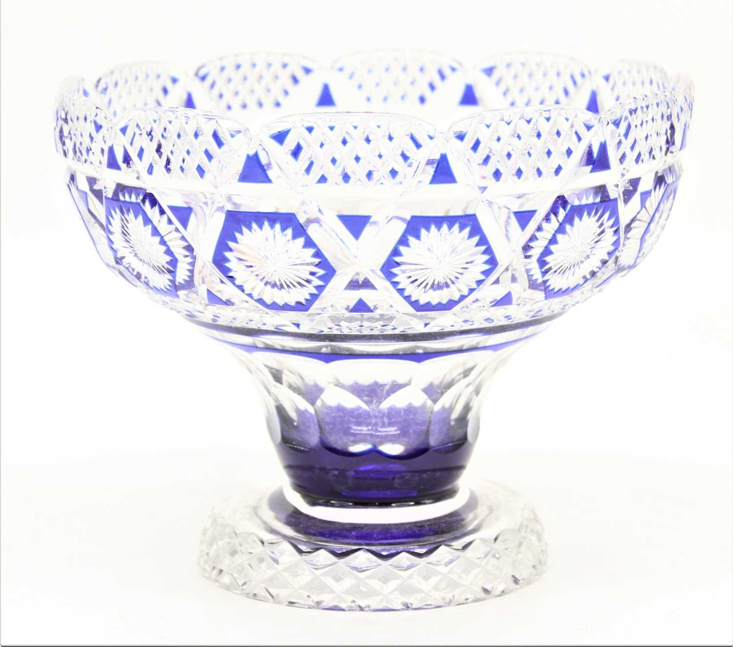 A blue overlaid crystal bowl, having star and diamond cut decoration, height 18cm