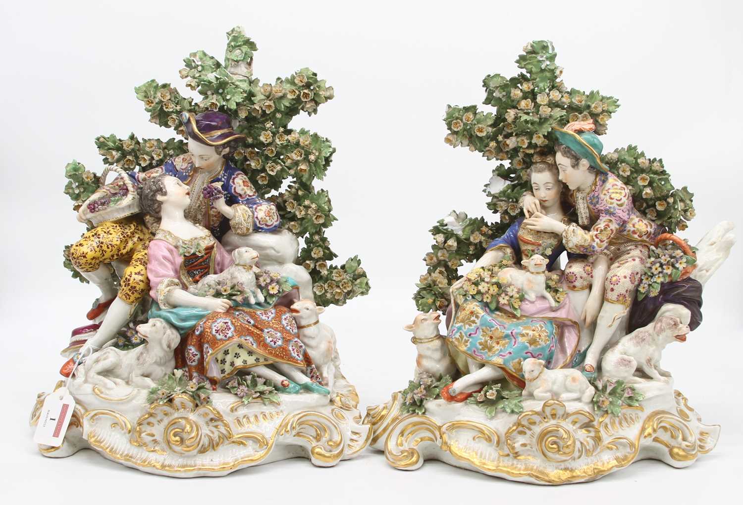 A pair of 19th century hard paste porcelain bocage figure groups, after Chelsea, each depicting a