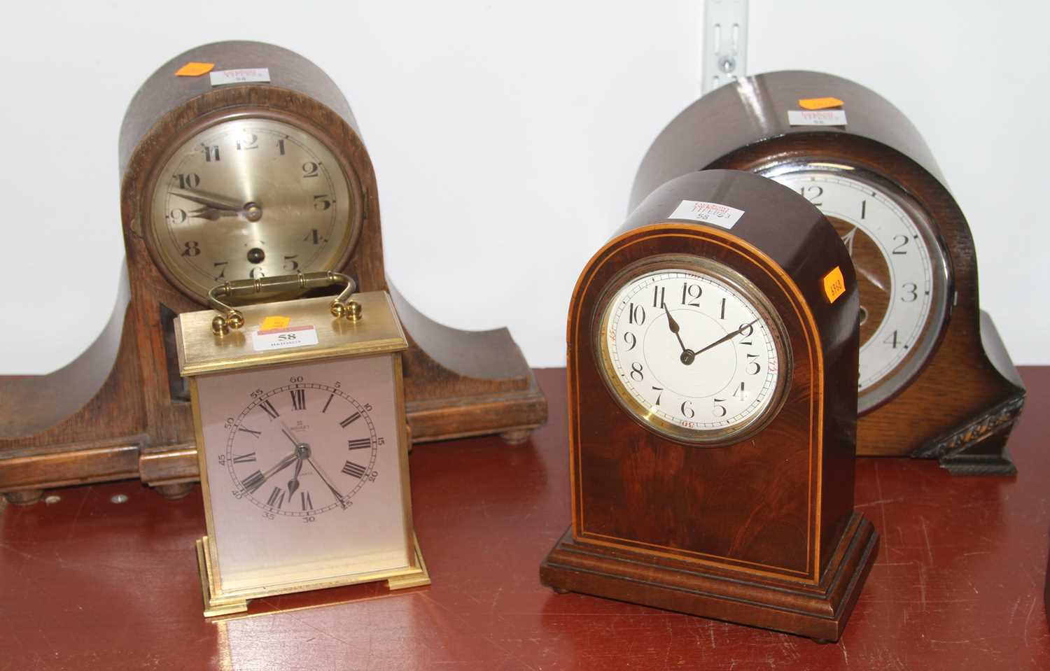 An Edwardian mahogany cased mantel clock, the enamel dial showing Arabic numerals 21cm, together