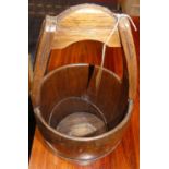 An Eastern stained wood and metal bound grain bucket