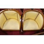 A pair of 1930s oak framed tub chairs, with yellow silk padded upholstery, each w.55.5cm