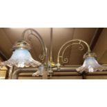 A pair of Art Nouveau lacquered brass three branch hanging ceiling lights, having opalescent