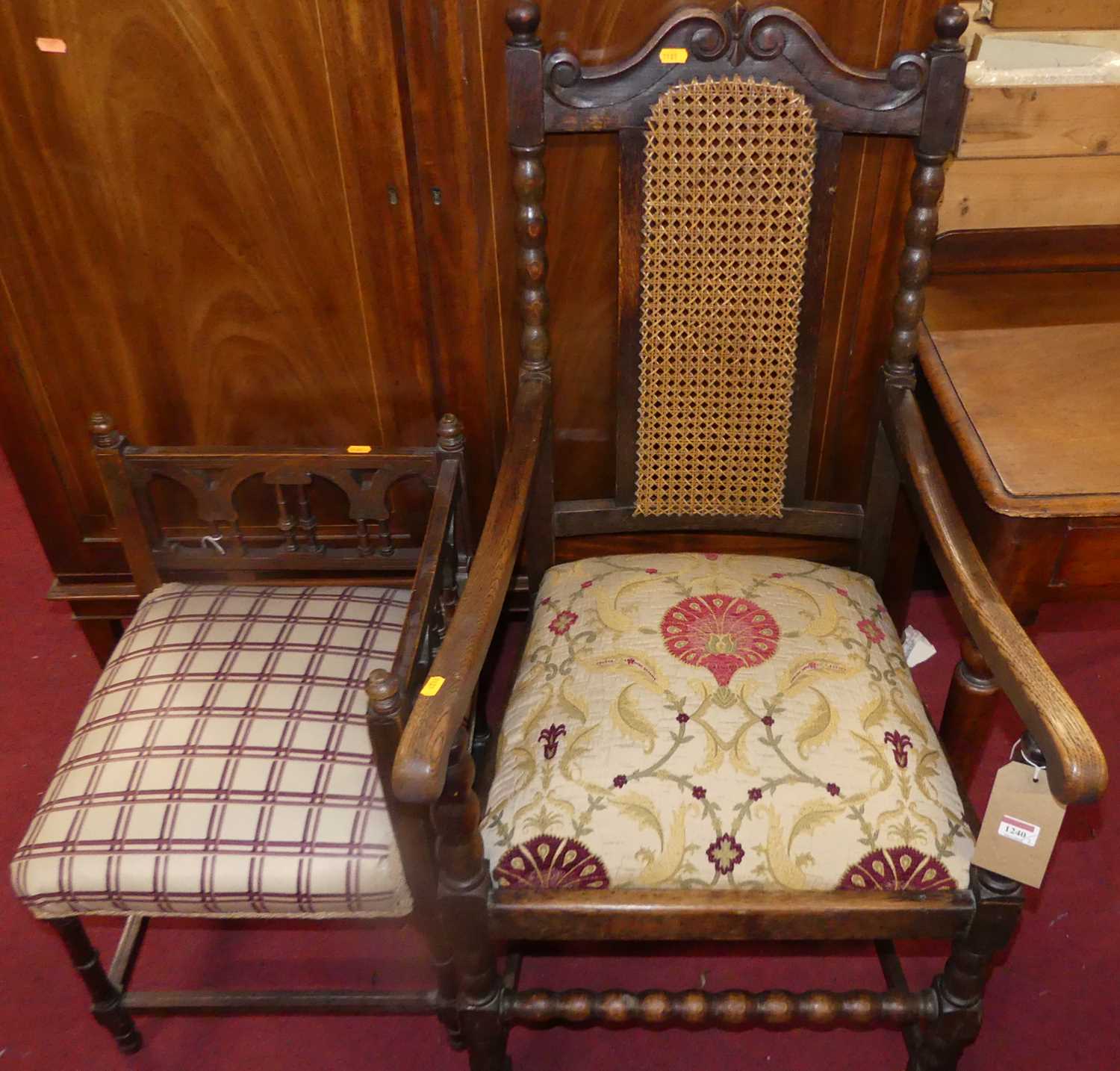 An early 20th century oak elbow chair, with floral needlework drop-in seat; together with an