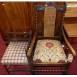 An early 20th century oak elbow chair, with floral needlework drop-in seat; together with an