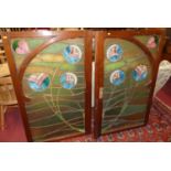 A pair of pitched pine and bright colour leaded stained glass inset cabinet doors, each measuring