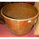 A circa 1900 copper twin handled riveted circular log bucket, dia.47.5cm