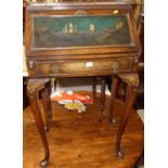 An early 20th century walnut and polychrome decorated lady's slopefront single drawer writing