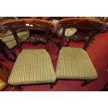 A set of four William IV mahogany scroll fanned barback dining chairs, having striped upholstered