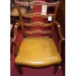 A 19th century mahogany ladderback single elbow chair, having tan leather studded stuffover seat,