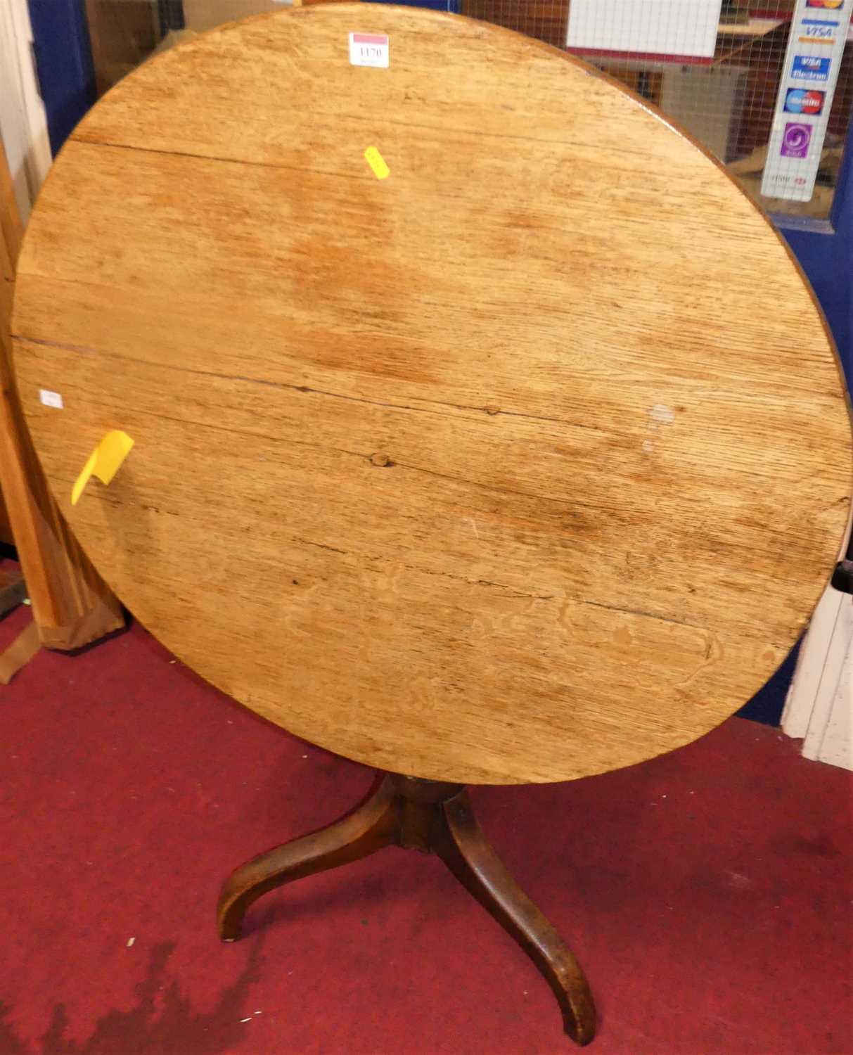 A 19th century oak and fruitwood circular tilt-top tripod table, dia.83.5cmAge related marks. Has