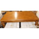 A hardwood plank topped round cornered coffee table, length 136cm
