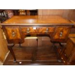 A 19th century mahogany and crossbanded three-drawer lowboy, on shell capped cabriole supports, w.