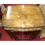 A walnut nest of three occasional tables, the largest w.53cm