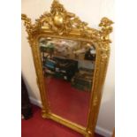 A contemporary French style floral and cherub decorated arched overmantel mirror, 162 x 83cm