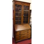 A 19th century mahogany, rosewood inlaid and chequer strung bureau bookcase, having twin lancet