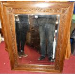 An early 20th century floral relief carved oak bevelled rectangular wall mirror, 110 x 87cm