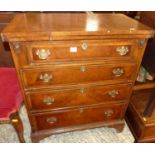 An early 20th century walnut and crossbanded foldover bachelors chest, of four long graduated