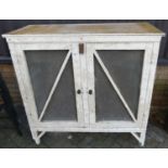 A white painted pine and mesh grille inset double door food cupboard, w.121cm