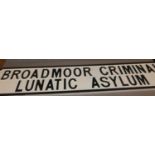 A painted wall sign titled 'Broadmoor Criminal lunatic Asylum'