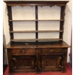 A provincial 18th century joined elm and fruitwood dresser, the later three-tier rack over unusual