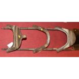 A 19th century Middle-Eastern hardwood and brass mounted twin camel saddle, length 131cm