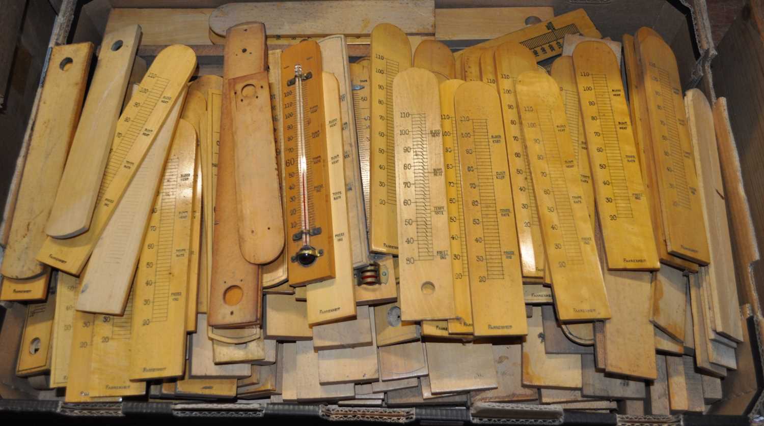 A large collection of boxwood thermometer scales, largely being bow topped