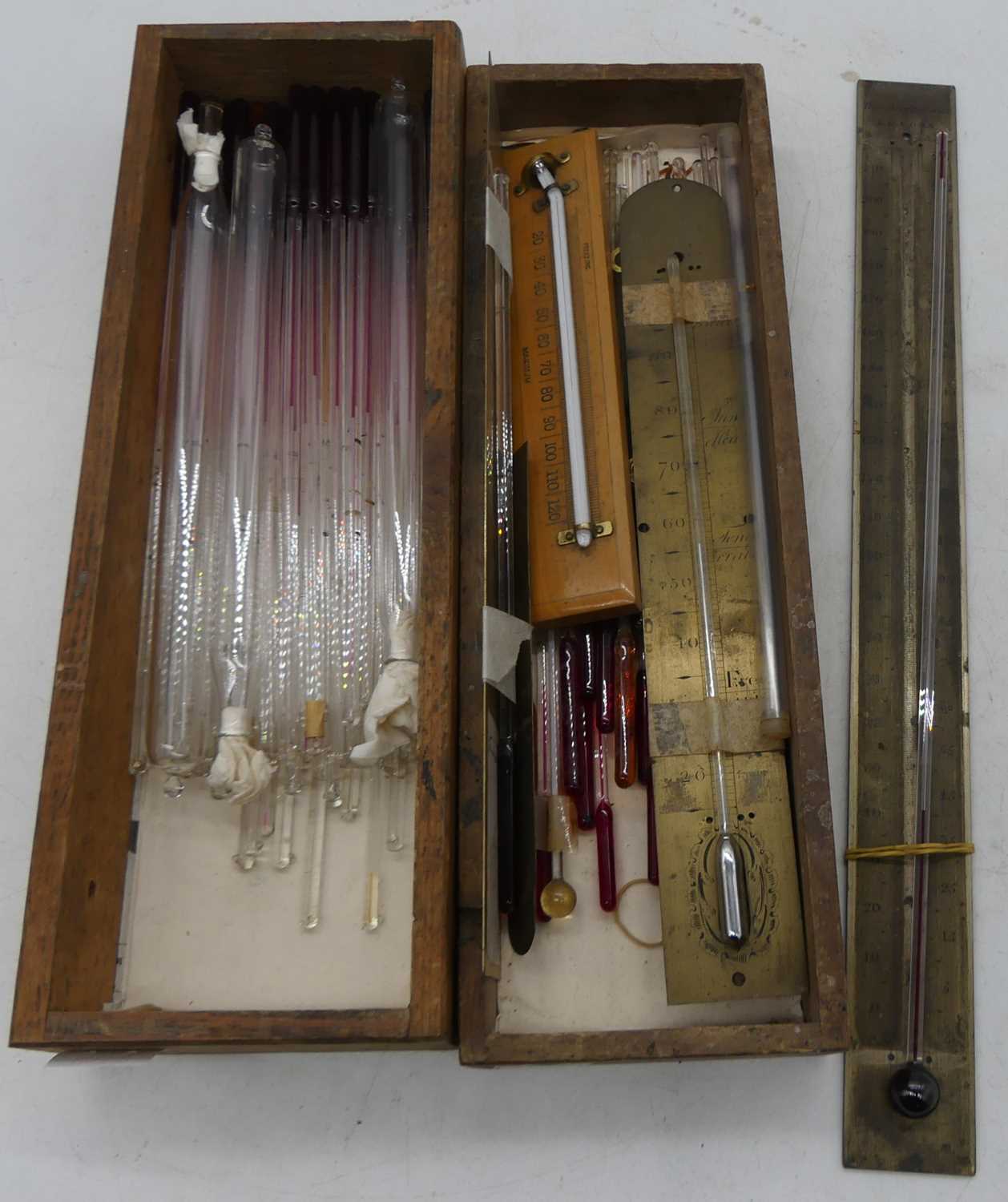 A collection of thermometer tubes, storm bottles, and scales