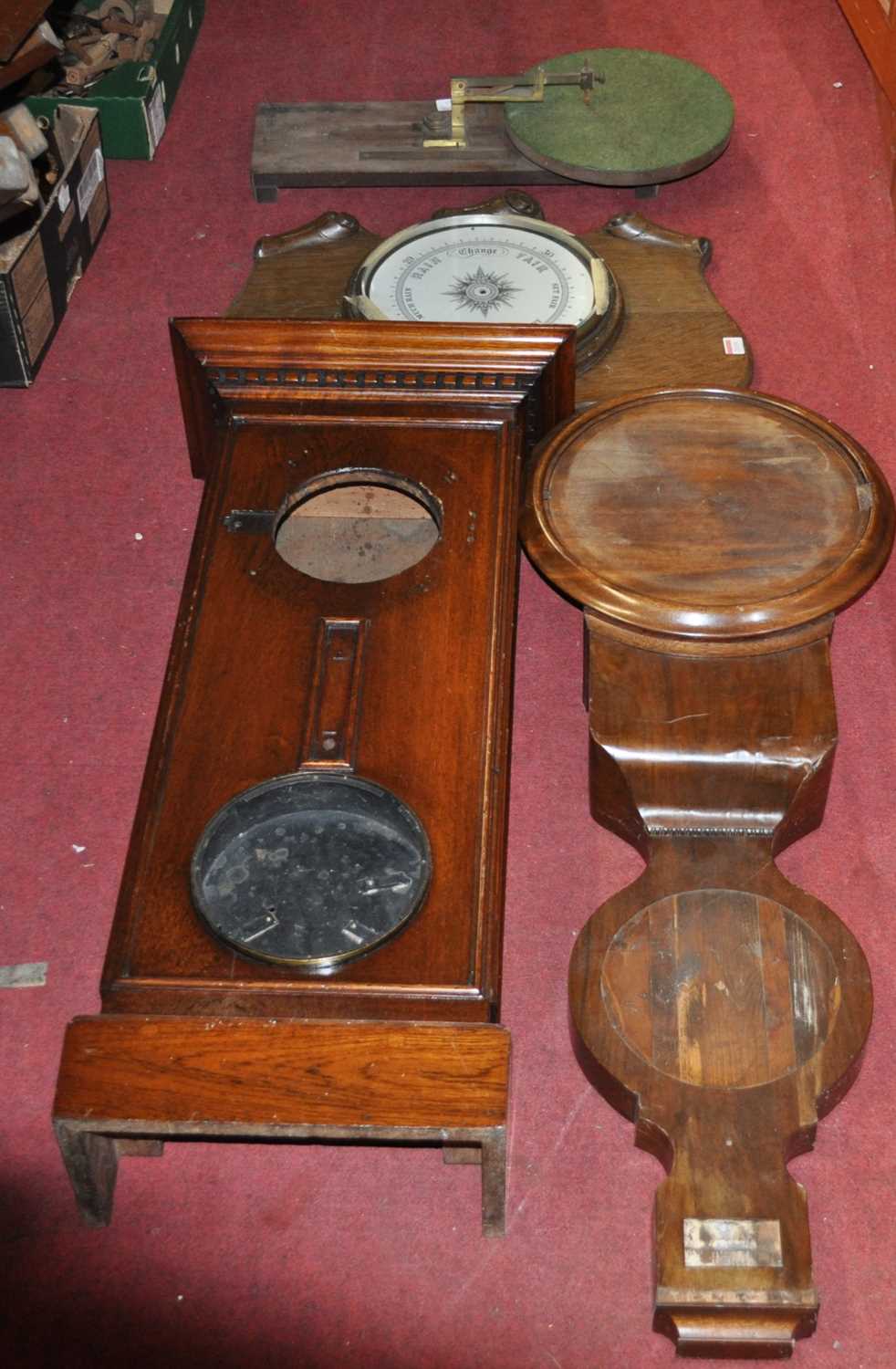An oak aneroid wheel barometer; together with a 19th century mahogany clock barometer case, an oak