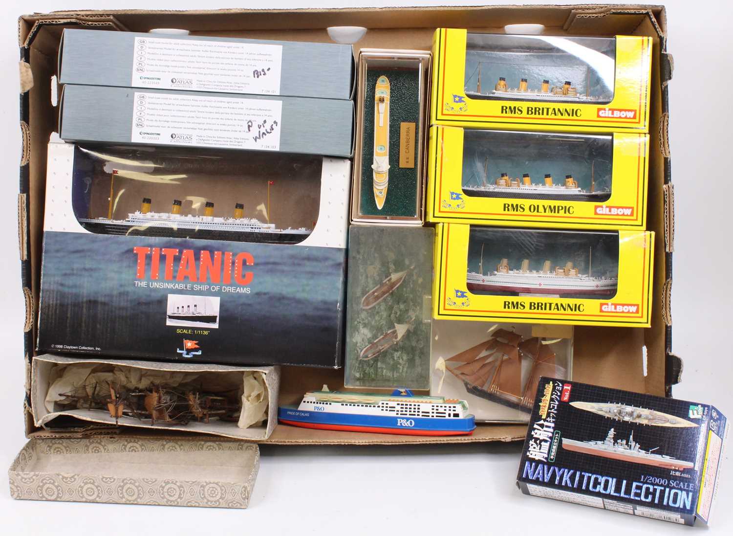 One box containing a collection of mixed scale diecast plastic and resin model ships to include an