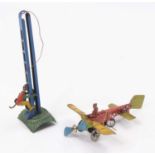 A German tinplate penny toy group, comprising of a tinplate monkey climbing blue pole with green