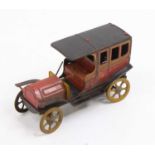 Charles Rossignol tinplate and clockwork car, comprising of red and yellow lithographed body with