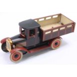 Orobr tinplate Thornycroft tipper truck, finished in black and red with fixed steering front wheel