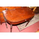 An early 19th century mahogany D-end fold-over tea table, having rear gateleg action and on ring