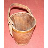 A tan leather, copper riveted and further bound swing handled tapering bucket, dia.27cm