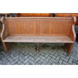 A late Victorian pitched pine four-seater church pew, w.184cm