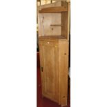 A rustic pine freestanding corner cupboard, having twin open shelved upper section, h.190cm