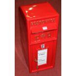 A reproduction red painted metal pole mounted post box, with lower lockable door