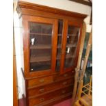 A late Victorian mahogany cabinet on chest, having twin glazed upper doors, with interior shelves