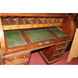 A Victorian mahogany cylinder topped twin pedestal writing desk, having a fitted interior and hinged