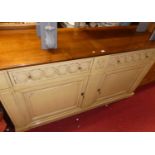 A contemporary cherry wood and cream painted Brassell sideboard, in the French taste, having twin