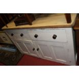 A Victorian pine and part-white painted round cornered dresser base, having twin frieze drawers over