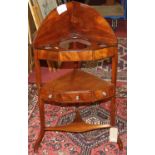 An early 19th century flame mahogany three-tier corner washstand